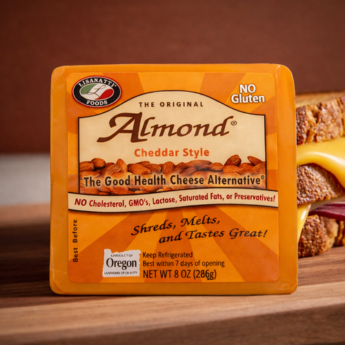Lisanatti Almond Cheddar Style cheese package on a wooden surface with a grilled cheese sandwich in the background